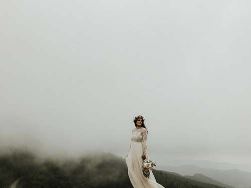 carver's gap woman wearing wedding gown standing on top of hill bakersville